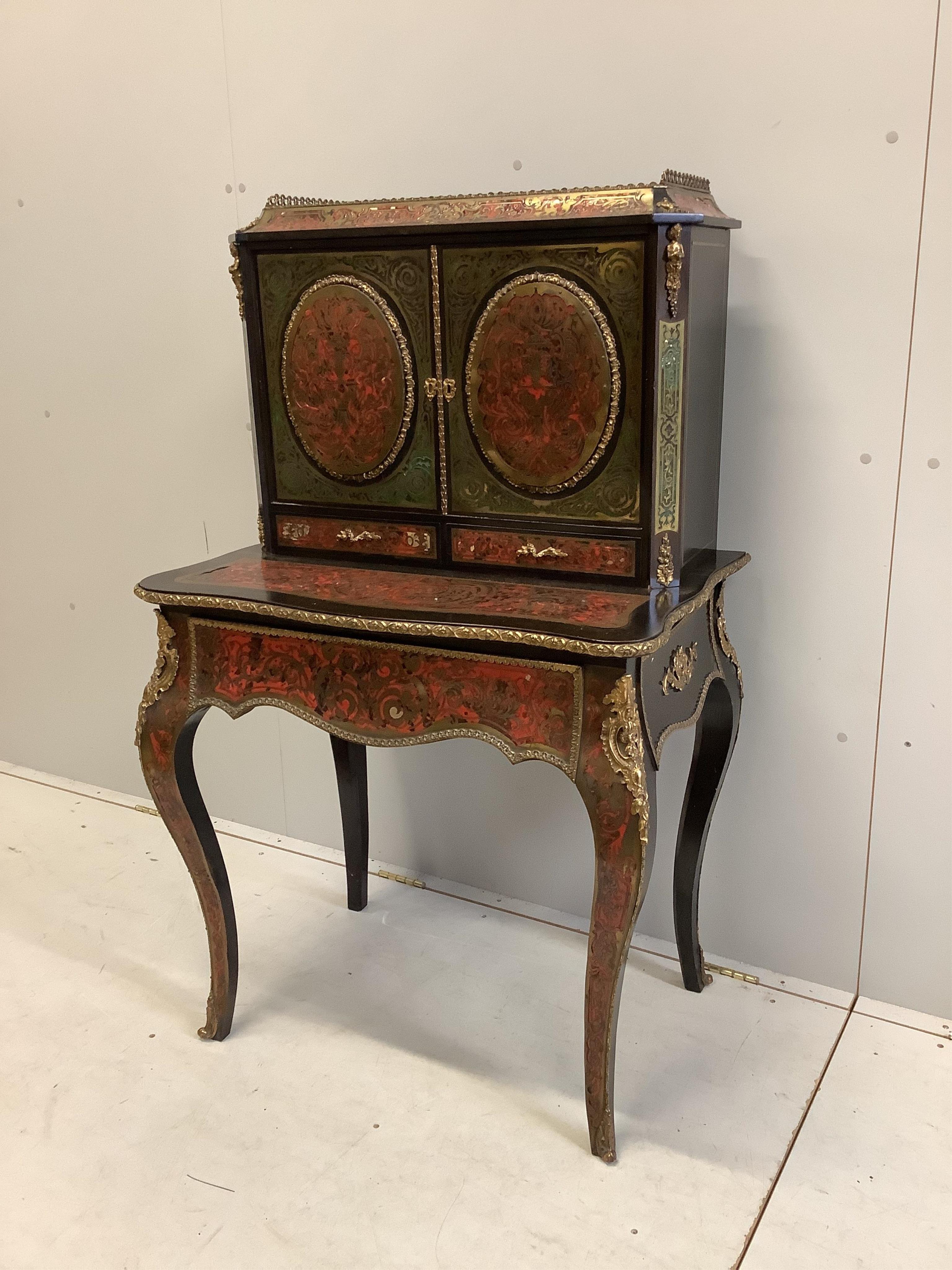 A 19th century French ebonized Boulle bonheur du jour, width 78cm, depth 54cm, height 128cm. Condition - fair to good, some minor losses and raised cut brass work.